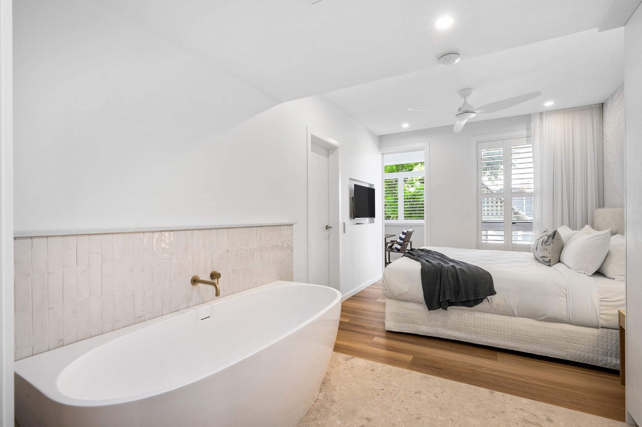 Ensuite bathroom with renovated marbled bathroom with modern fixtures