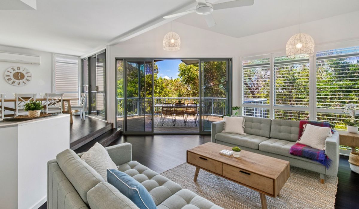 coastal Castaways Beach accommodation with bright open living area and leafy outlook