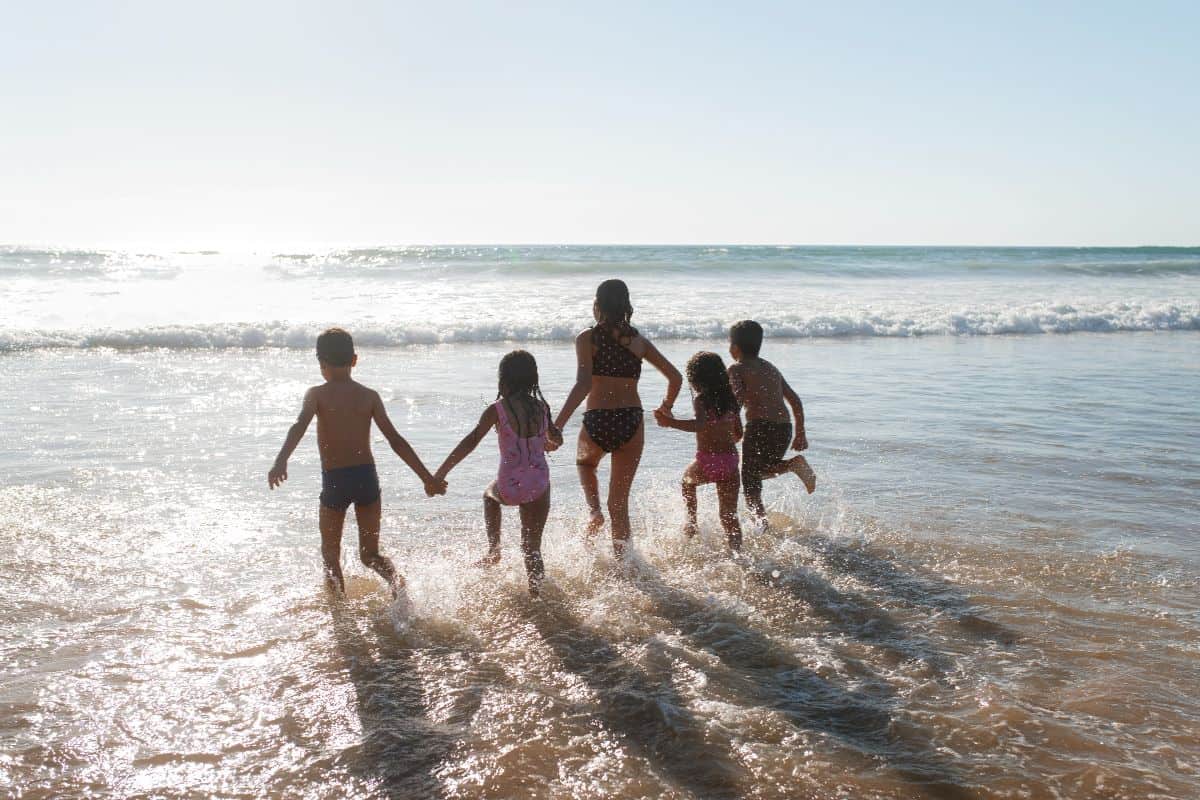 Seasonal Noosa getaways in summer, kids enoying the beach on holiday in Noosa